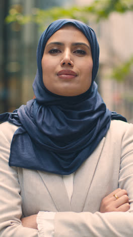 Vertical-Video-Portrait-Of-Muslim-Businesswoman-Outdoors-Standing-In-Front-Of-City-Offices